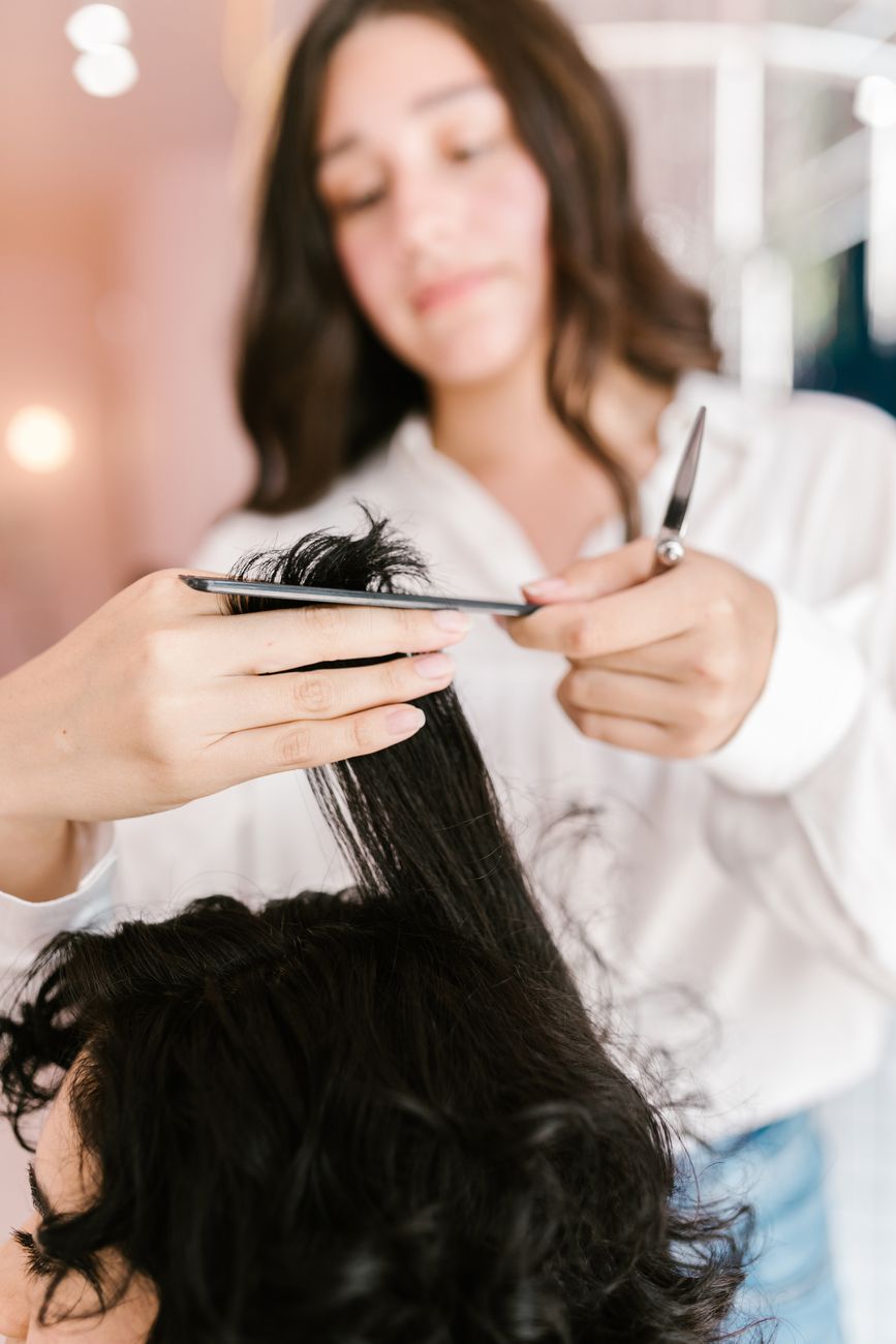 a woman doing hair cut