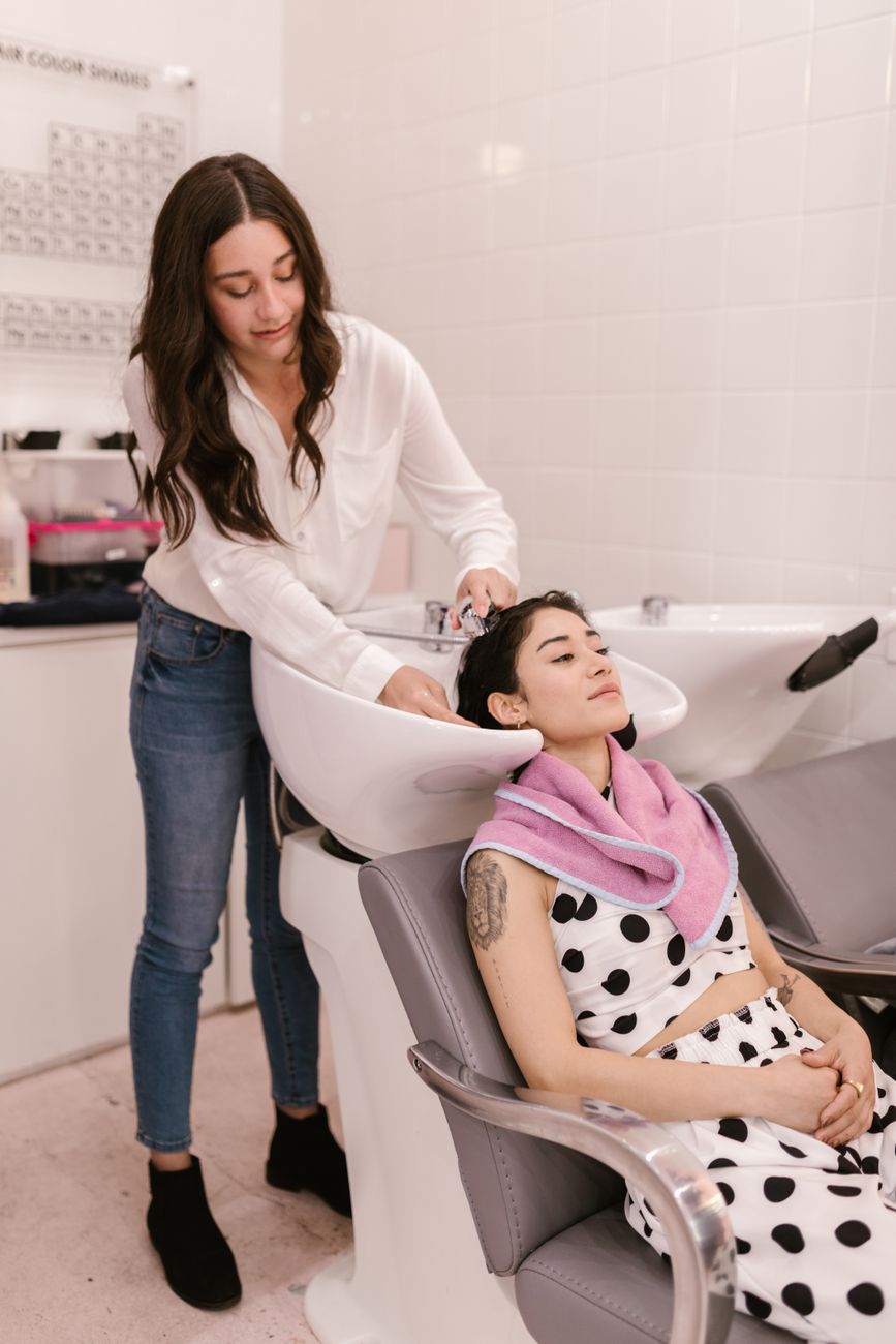 a woman shampooing a client