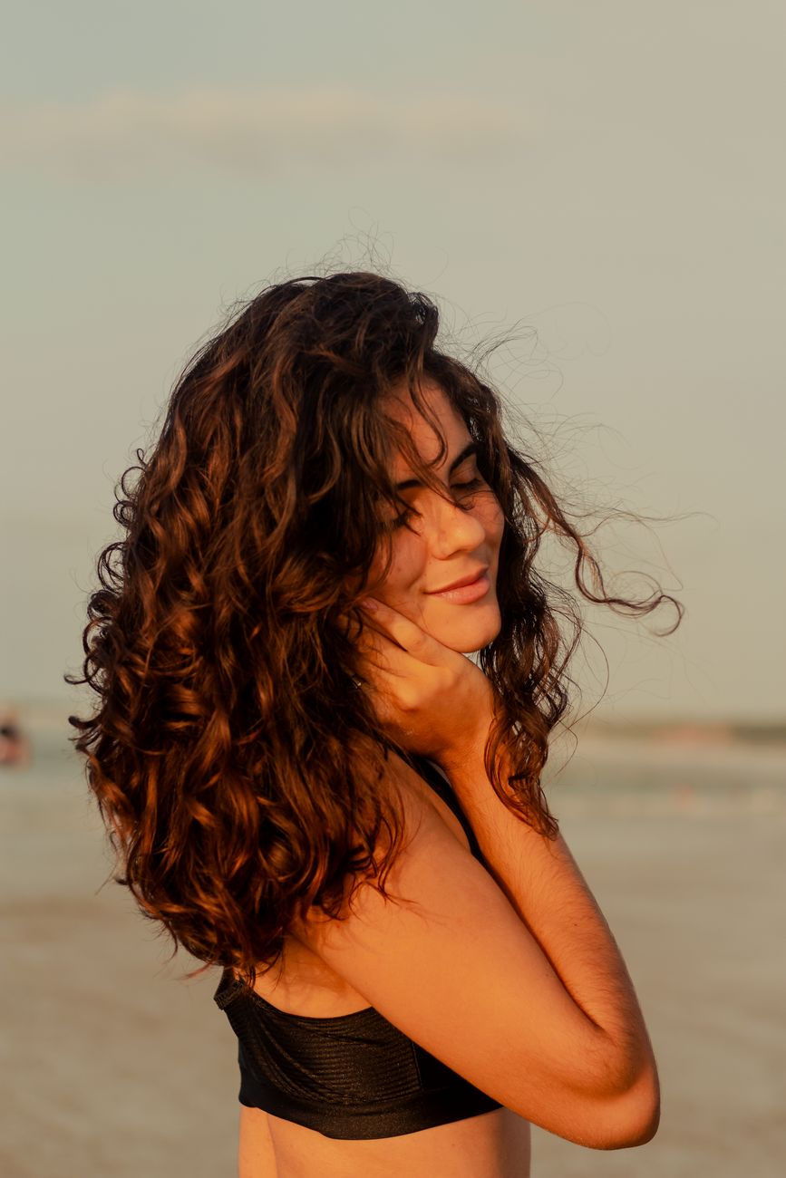 The Modern Perm Reborn: Throw Away Your 80s Misconceptions 1 woman in black swimwear