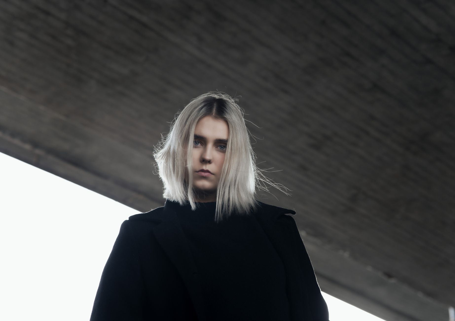 woman in black coat staring