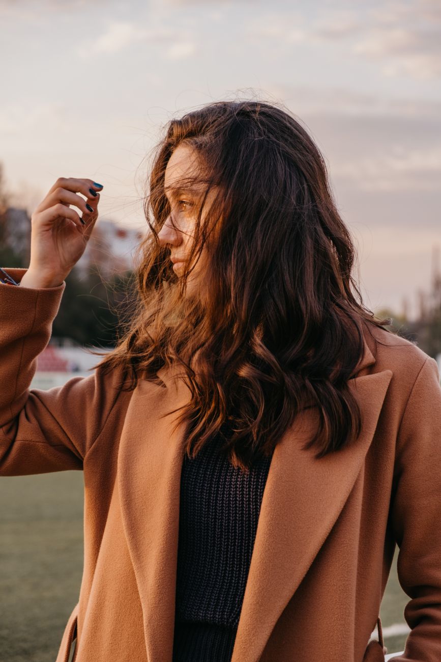 woman looking in direction of setting sun