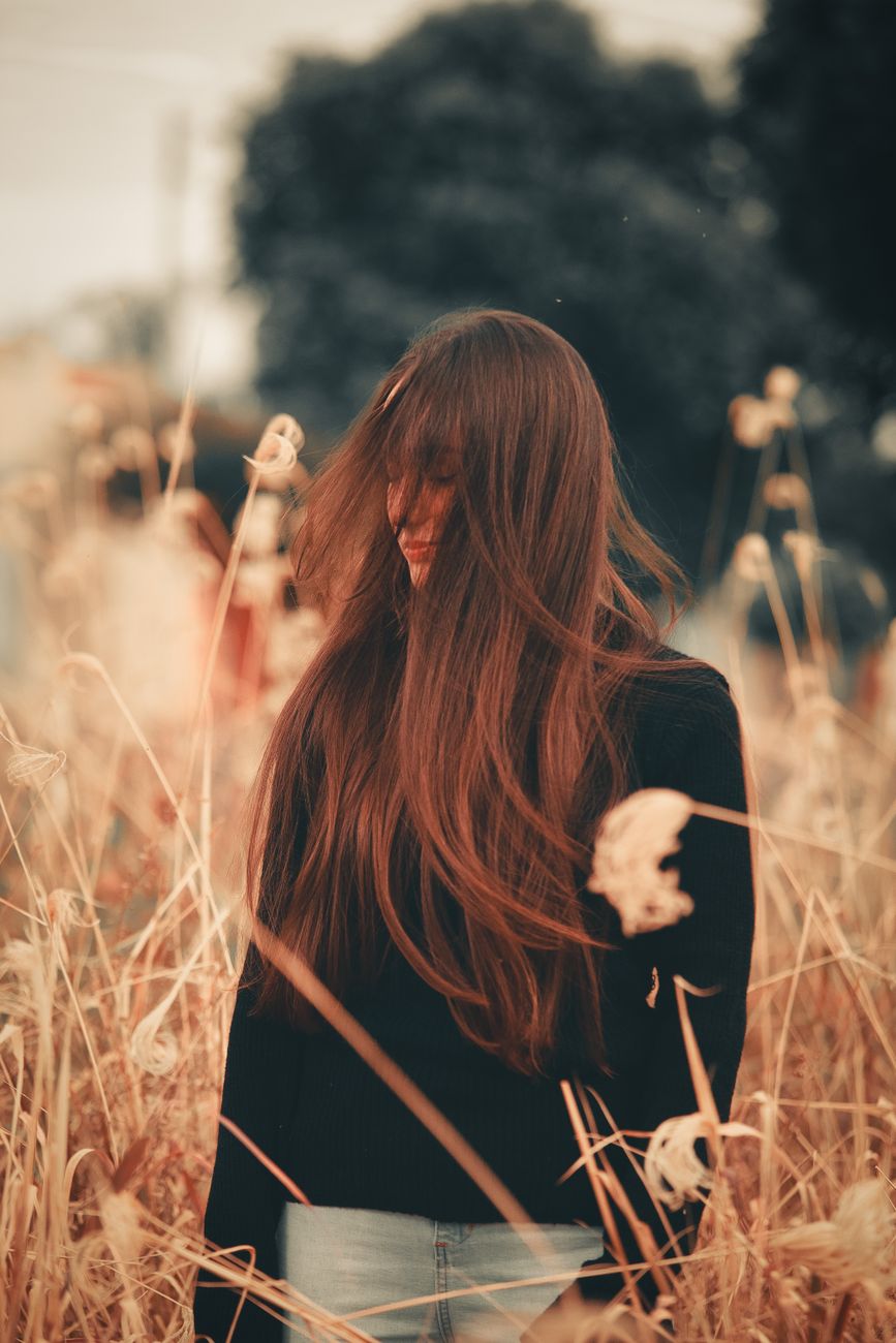 The Ultimate Guide to Purple Shampoo: How Much Is Too Much? 1 woman in black long sleeves standing on a grassy field