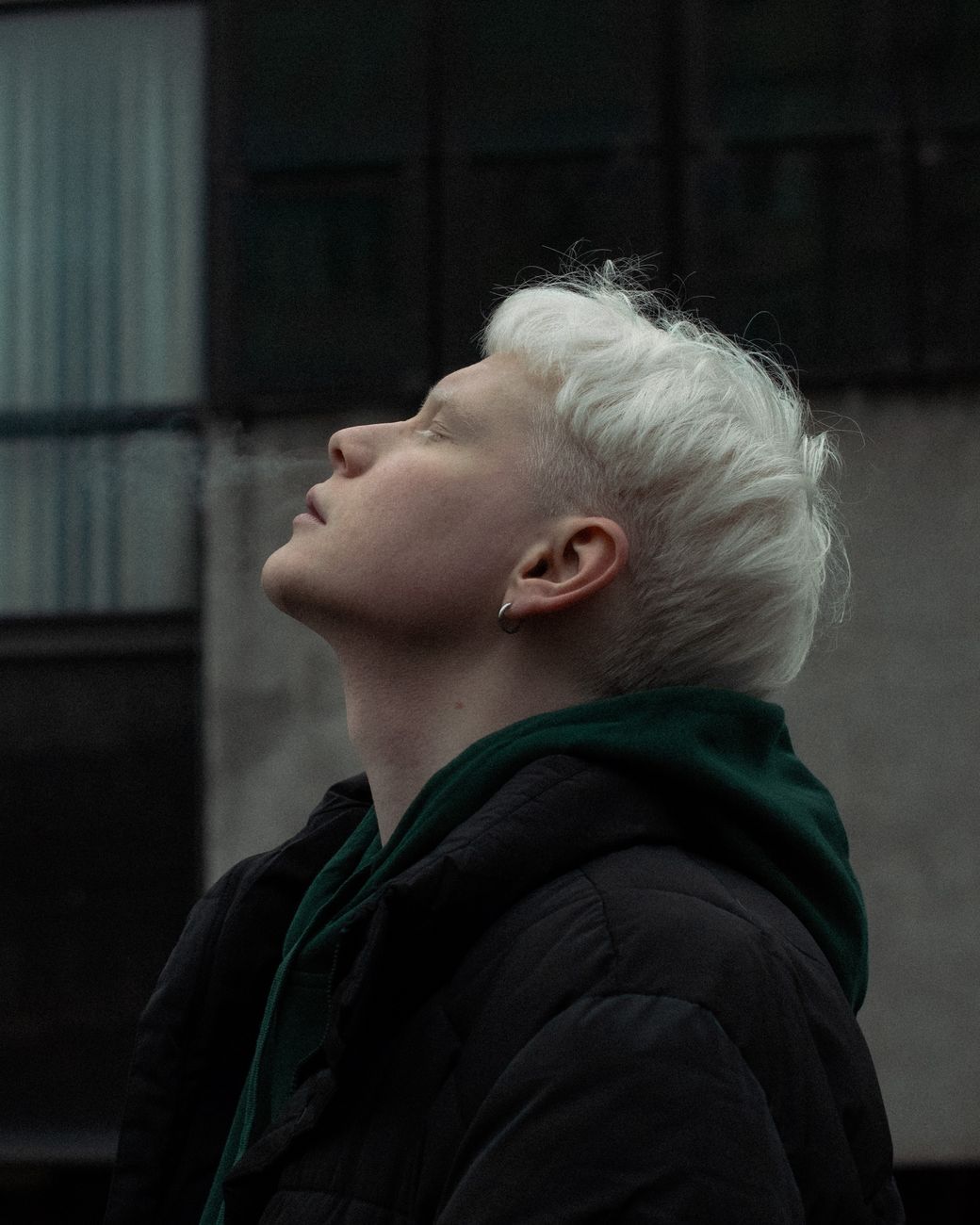 man exhaling smoke through nose