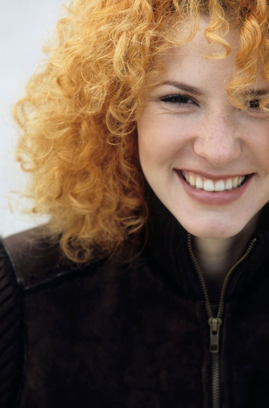 Can You Perm Lightened Hair? The Honest Truth from Just For Hair 1 portrait of a woman smiling