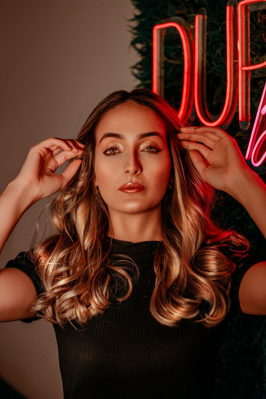 The Science of Lightener: How Balayage Keeps Hair Healthy 1 beautiful woman wearing a black top