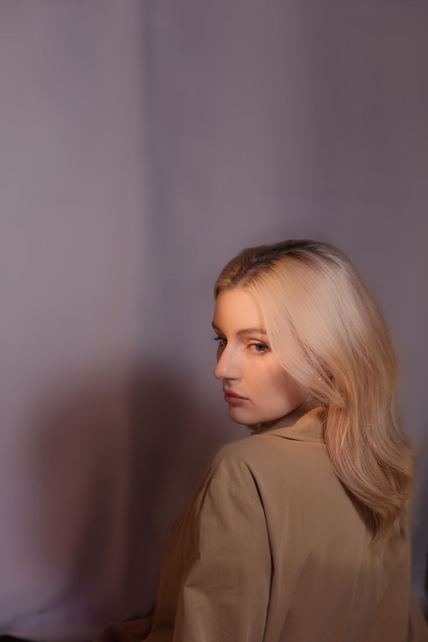 Over-Processed Blonde Recovery: Rebuilding Broken Bonds 1 portrait of a blonde looking over her shoulder