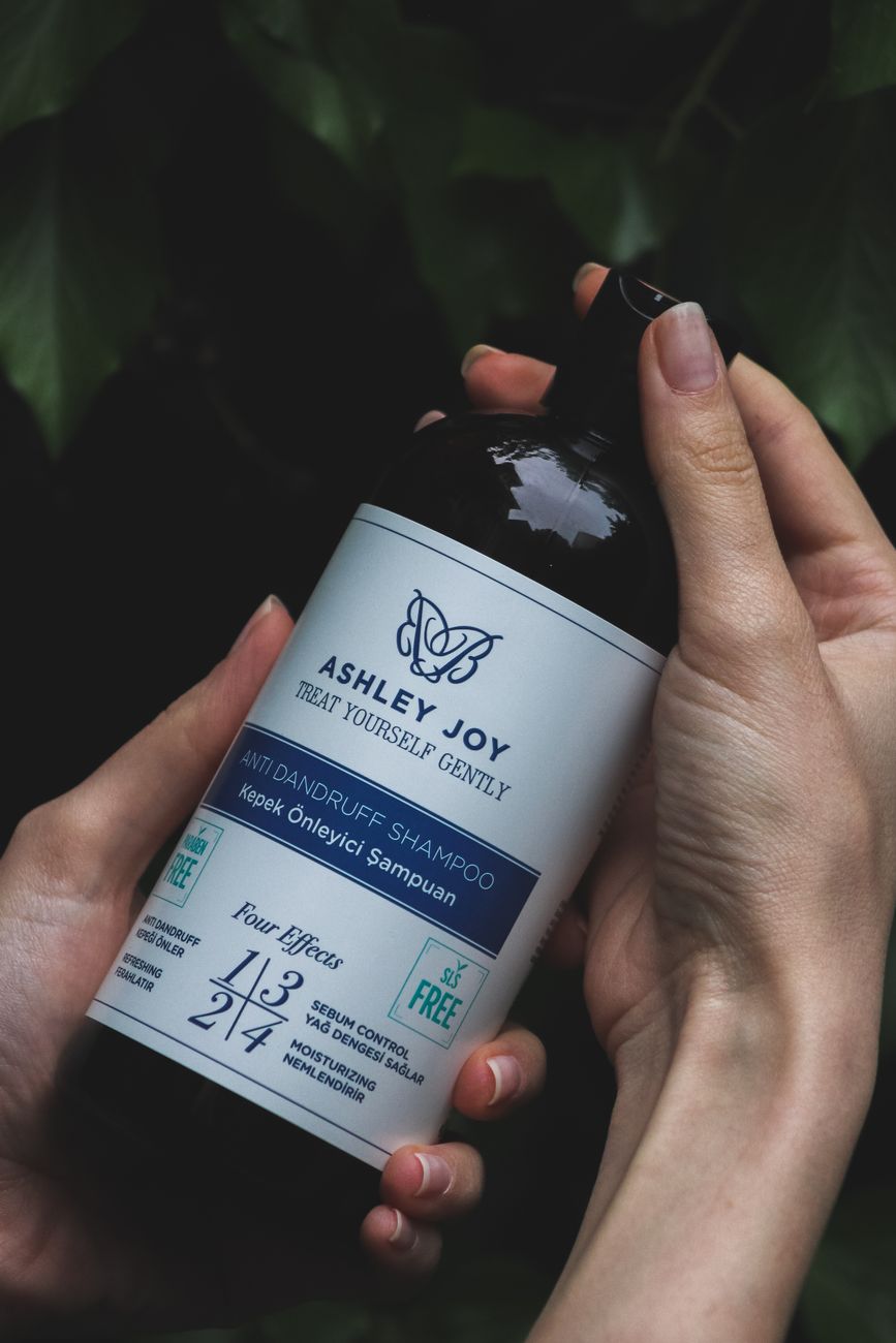 Clean Ingredient Deep Dive: Why Paraben-Free Matters for Hair Longevity 1 photo of hands holding a bottle of shampoo