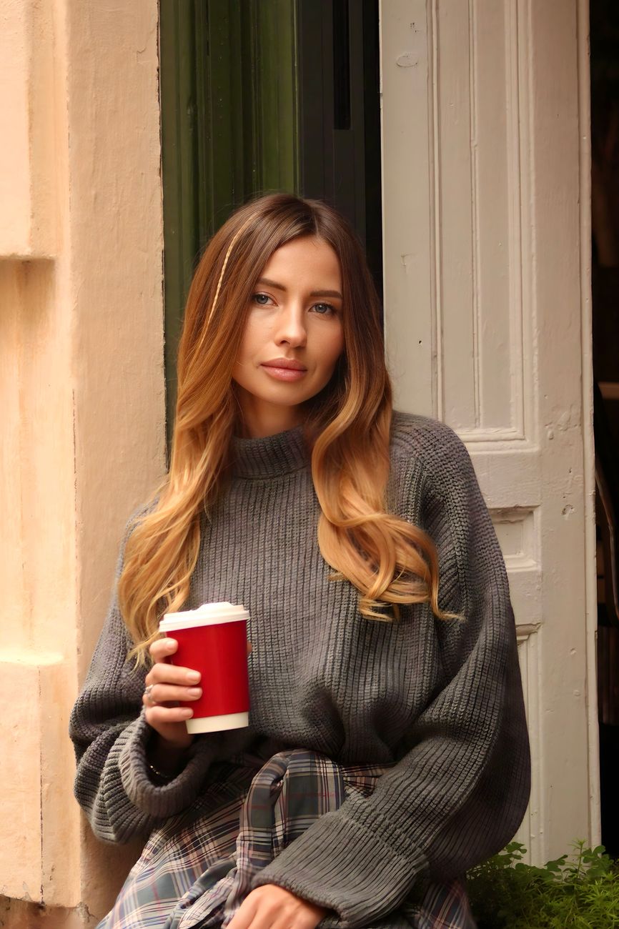 Mushroom Blonde Balayage: Trendy Earthy Hues 1 woman with disposable cup