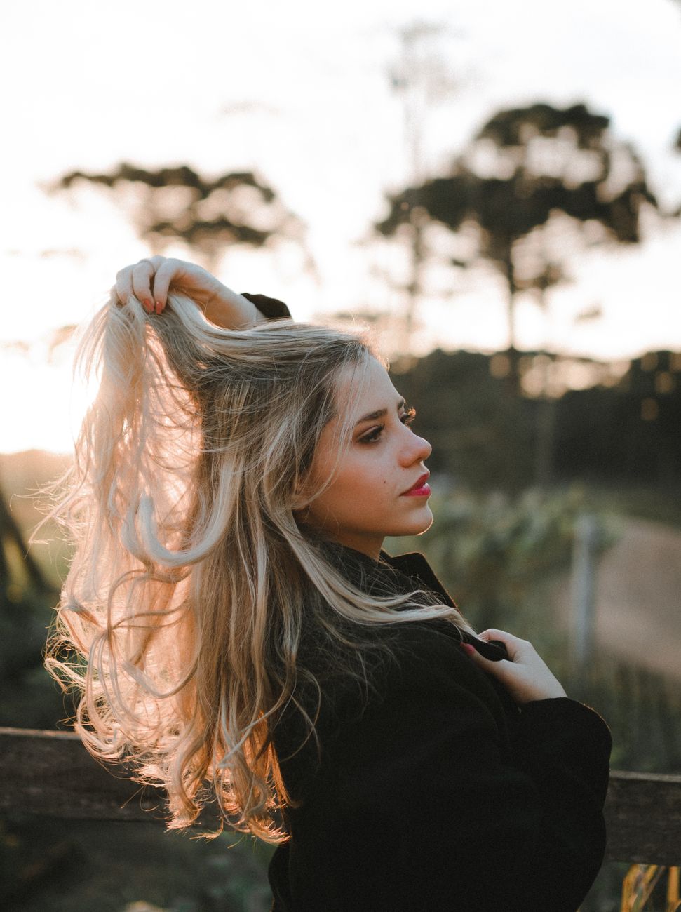 High-Lift Color vs. Lightener: Which Blonding Method Is Best? 1 portrait of blonde woman in sunlight
