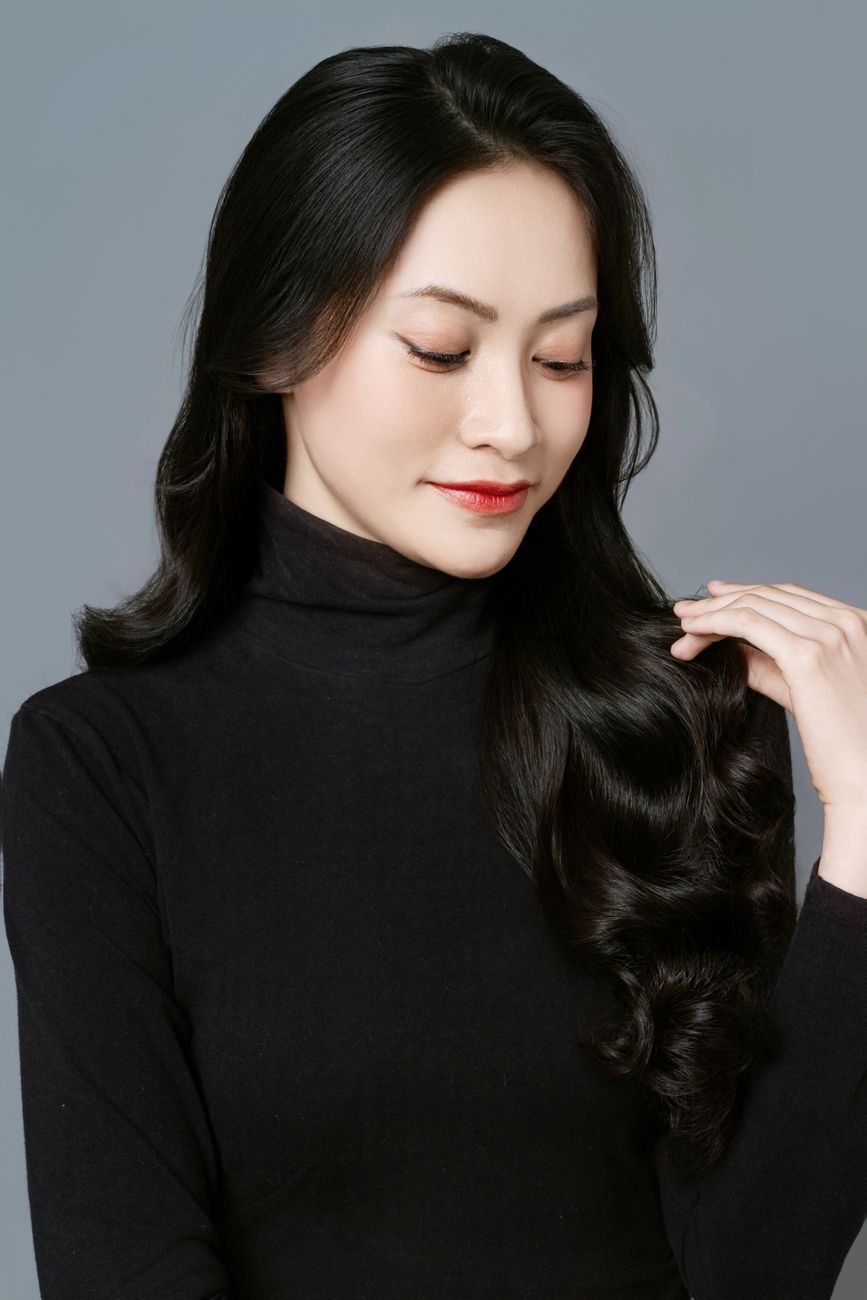 How Often Should You Get a Perm Touch-Up? Managing Root Growth 1 portrait of brunette woman in black dress