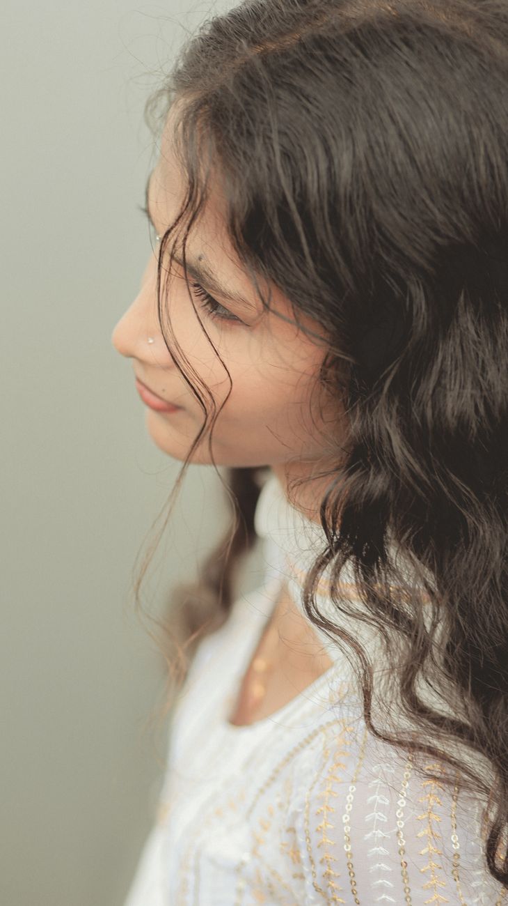 Keratin-Infused Perms: Strengthening Strands While Boosting Wave Patterns 1 portrait of a woman with curly hair in ernakulam