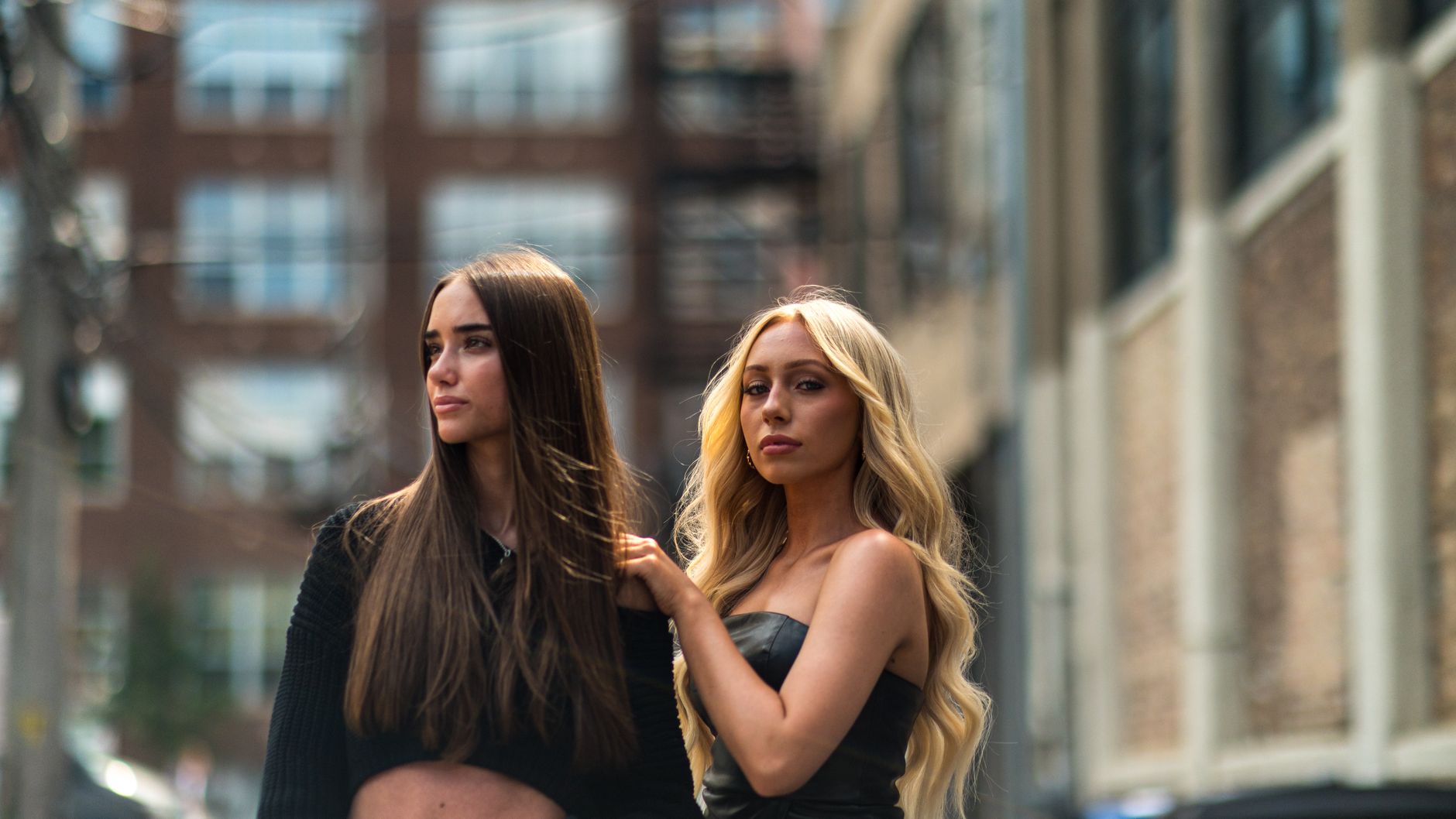 fashionable women posing in urban street