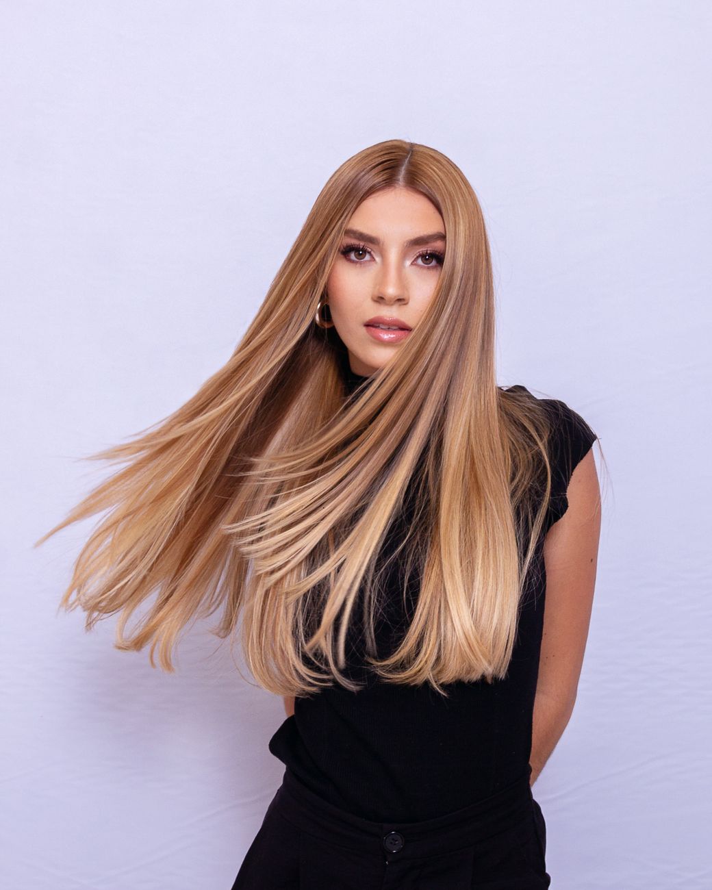 blonde woman with flowing hair in studio portrait