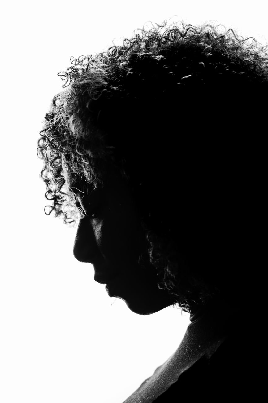 silhouette of woman with curly hair in profile