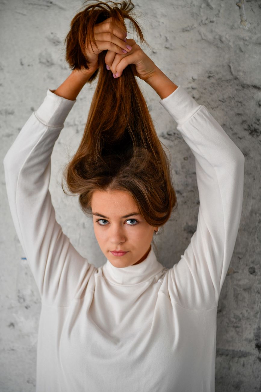 playful portrait of a young woman in white