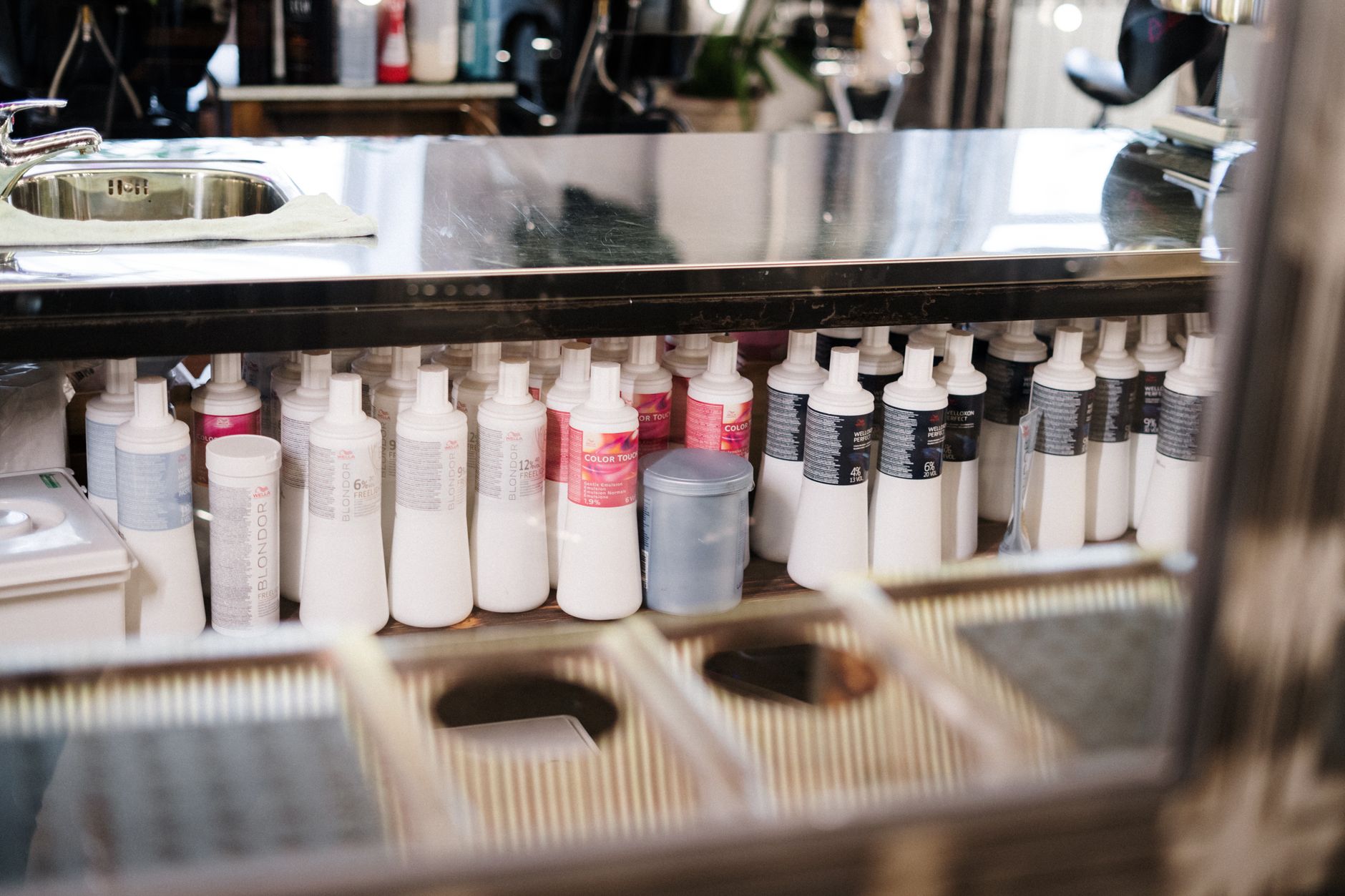 Bond Protectors Unveiled: Why We Never Do a Fashion Transformation Without Them 1 white plastic bottles on brown metal rack