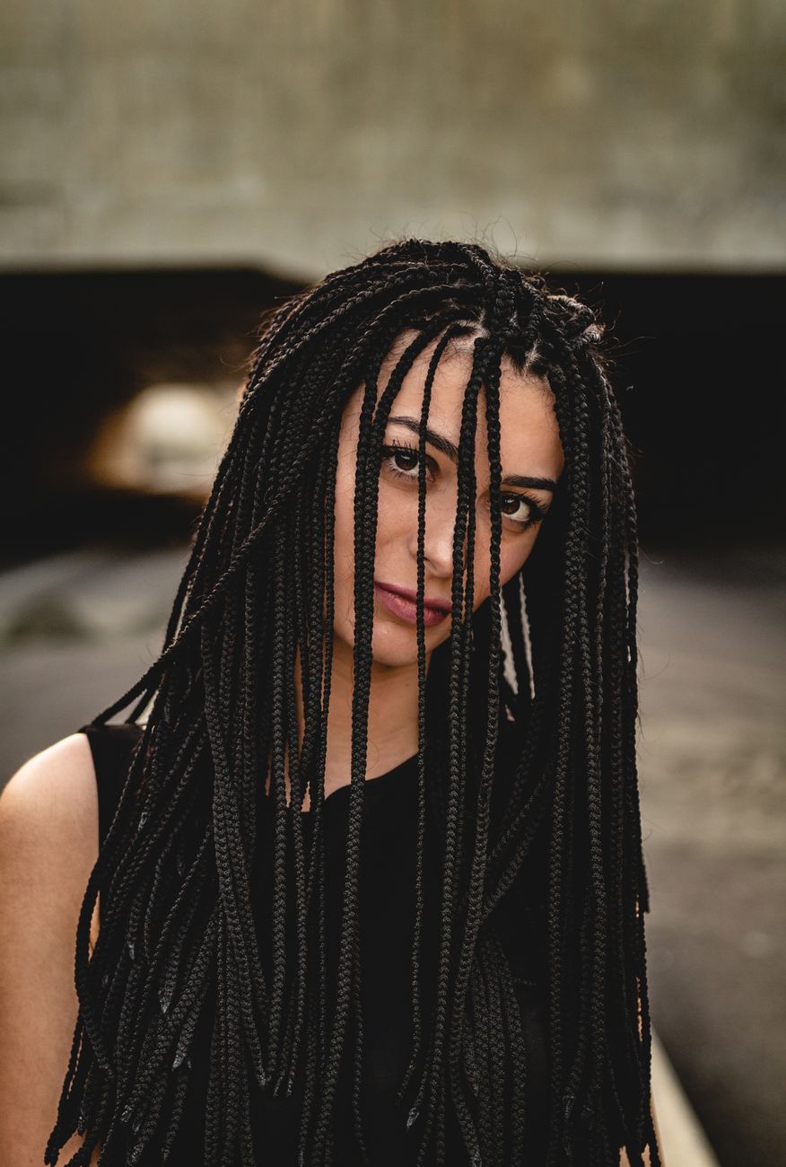 Taking Down Protective Styles: Avoiding Breakage During the Unravel Process 1 woman in black sleeveless top