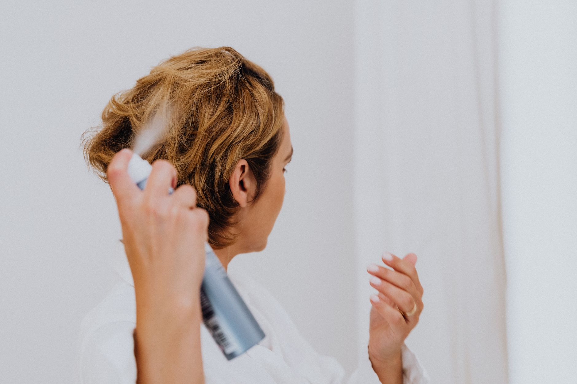 woman spraying her hair