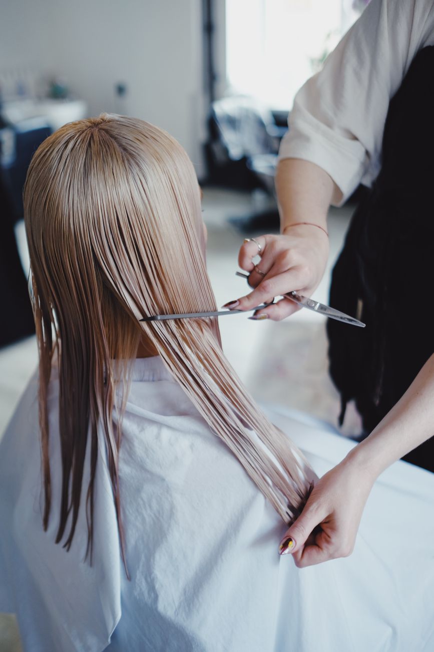 Sharp Step Cuts: Creating Dramatic Visual Shelving in Long Lengths 1 a blonde haired woman having a haircut