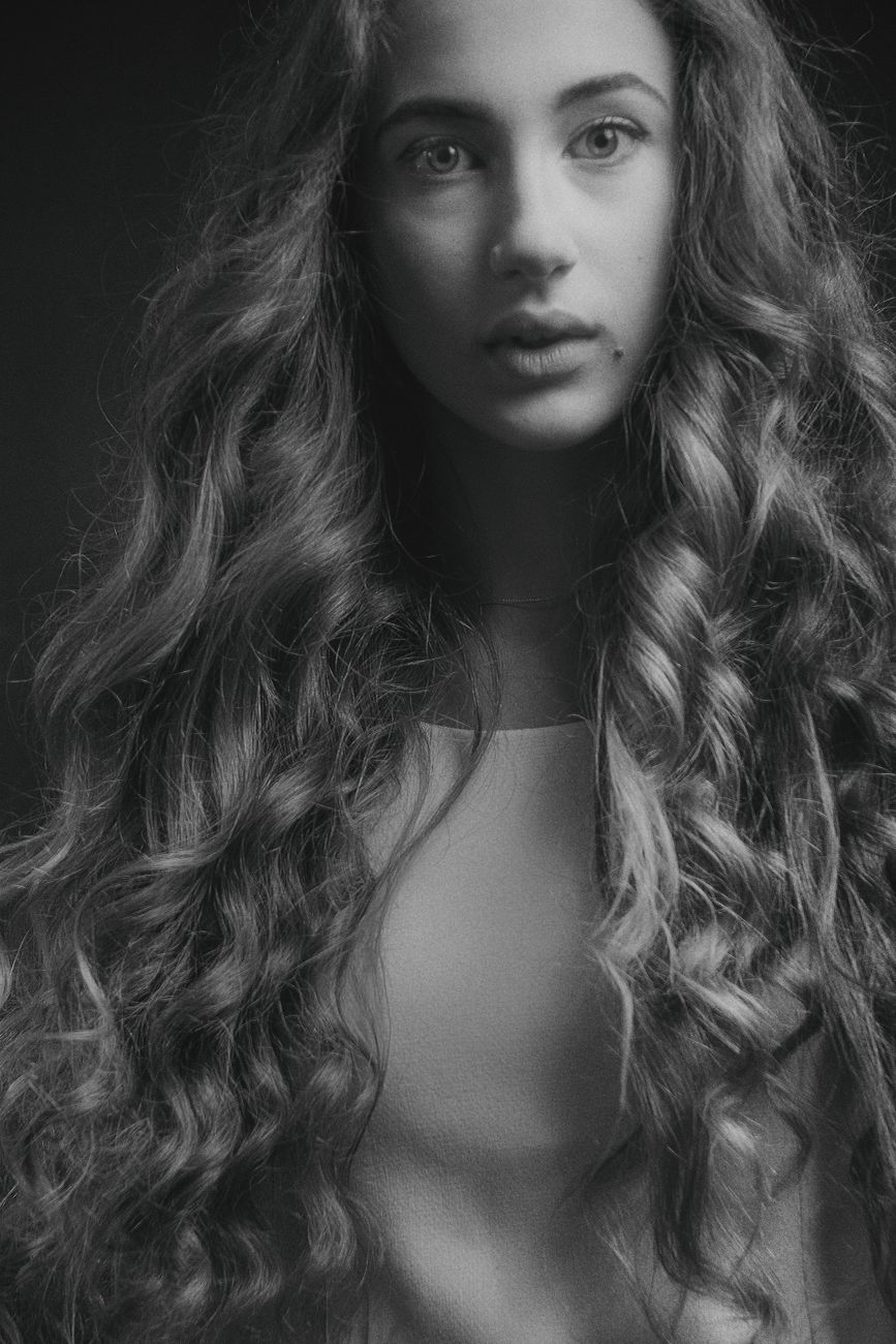 The Beach Wave Perm: Achieving Continuous Lived-In Waves Effortlessly 1 grayscale photo of woman with curly hair