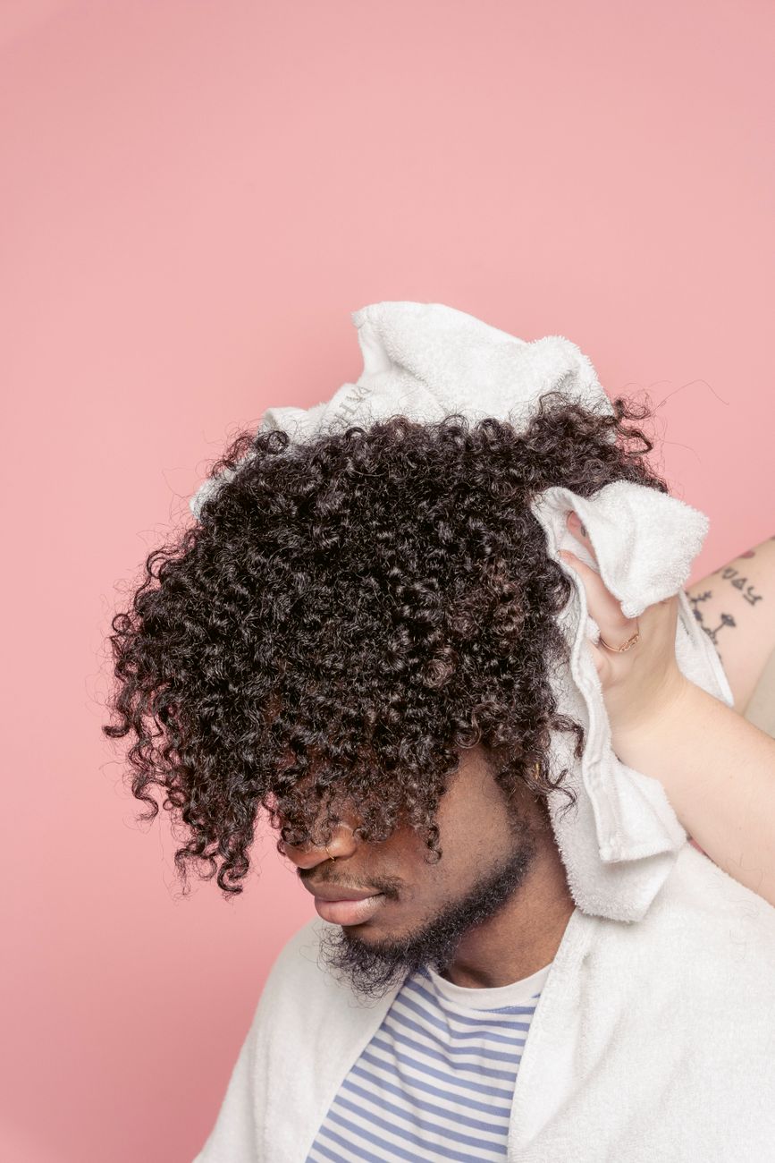 The Men's Textured Perm: Adding Movement to Straight Top Lengths 1 anonymous stylist drying hair of black client
