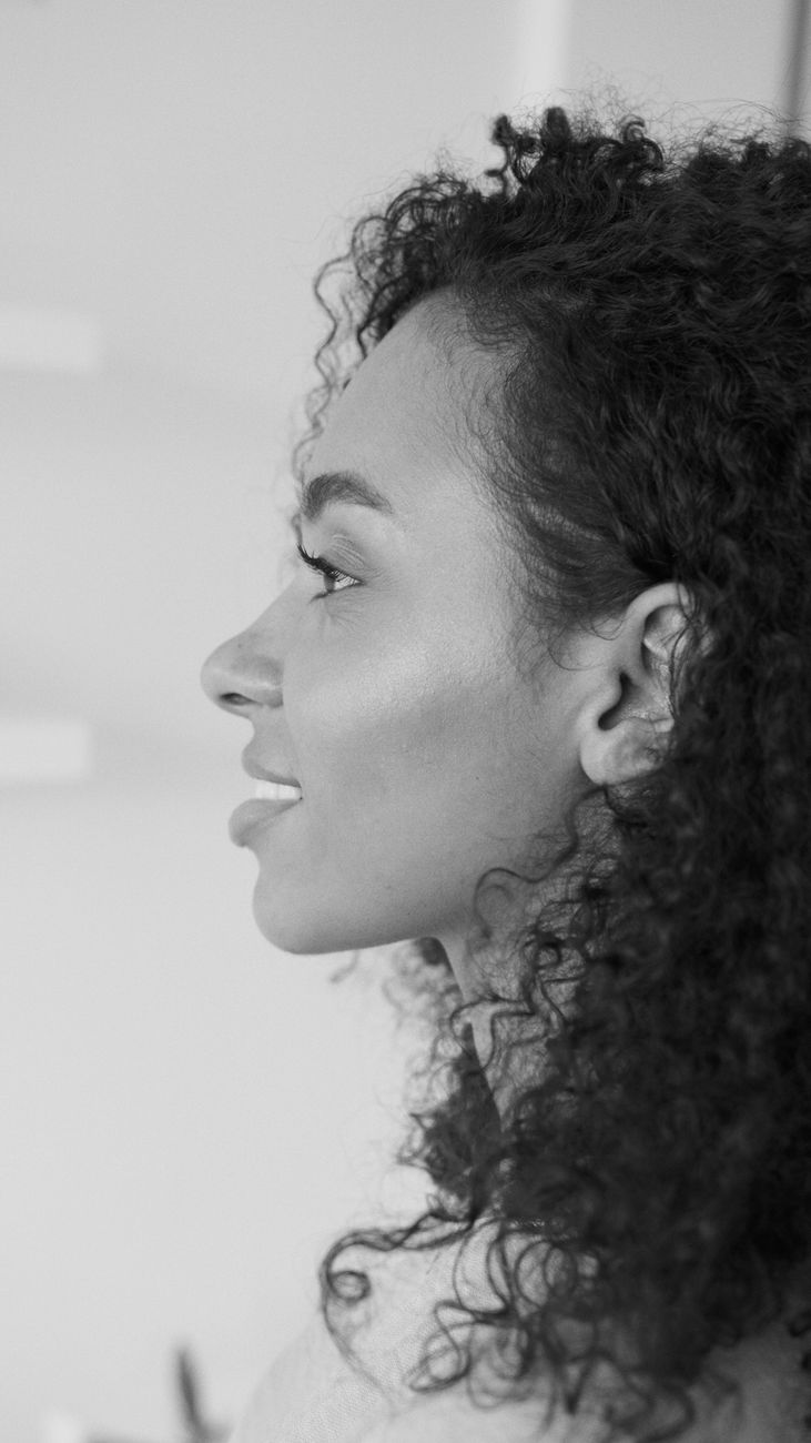 The Silk Press Process: Frizz-Free Smoothness for Natural Textures 1 grayscale photo of a woman with curly hair