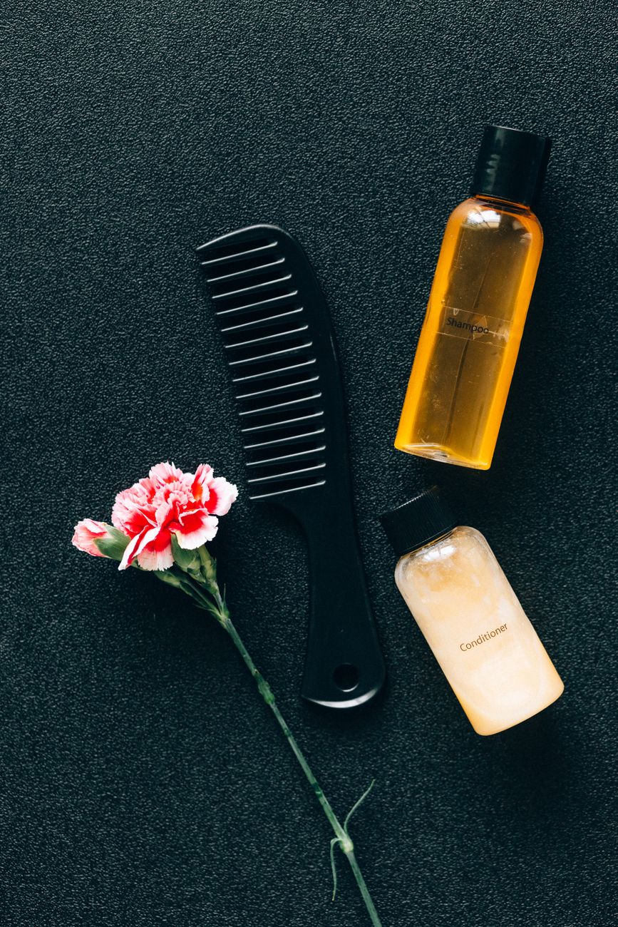 Hydration Station: Essential Leave-In Conditioners for Permanent Waves 1 black hair comb on the table