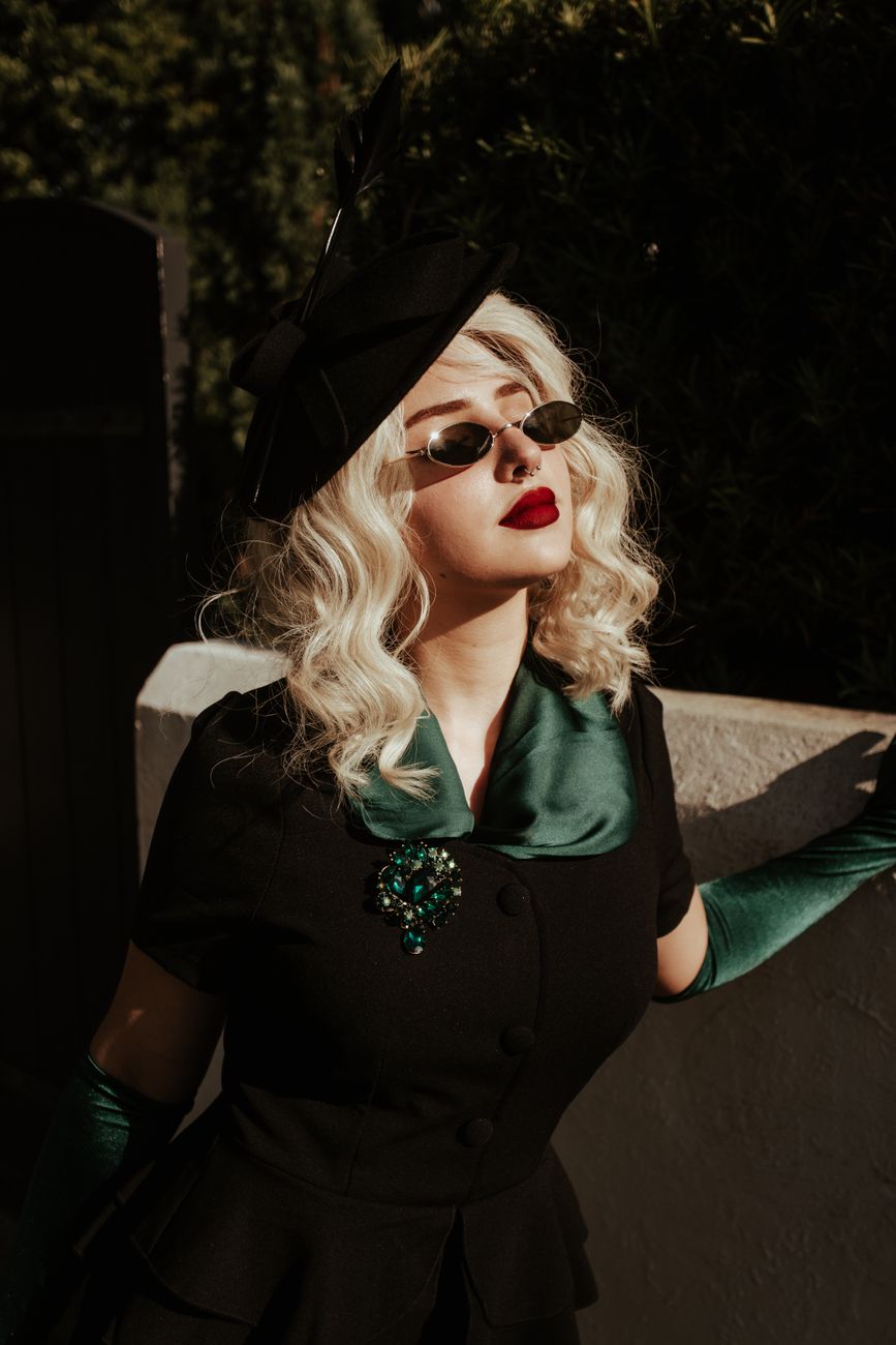 blonde woman with red lipstick wearing black sunglasses