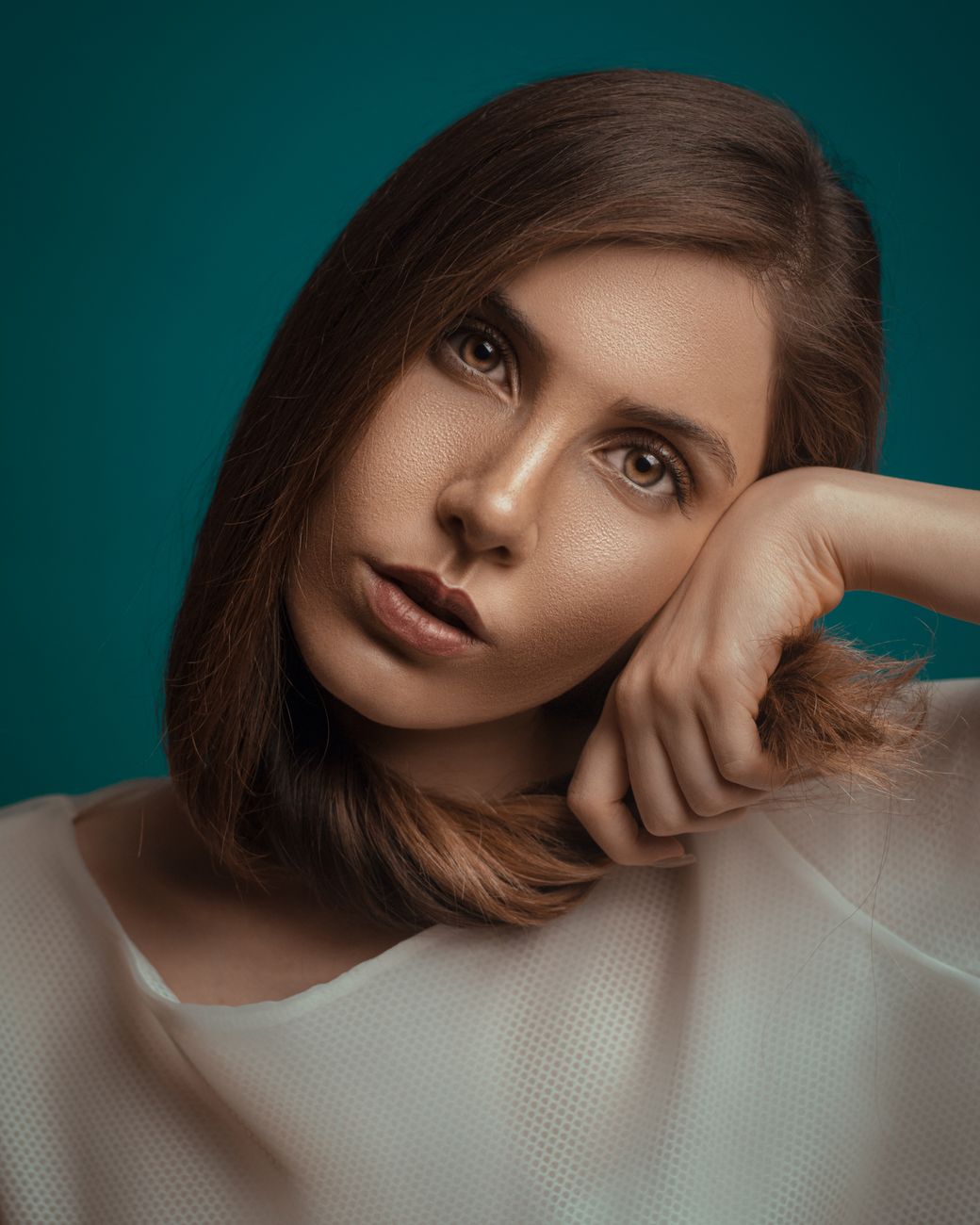 Teal Hair Goals: Rich Ocean Tones for Every Style 1 portrait of woman resting her head on hand
