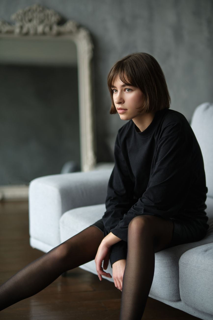 French Bob Styles with Custom Fringe Details 1 portrait of girl sitting on sofa