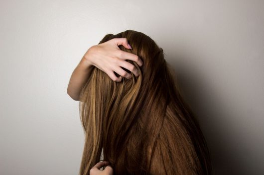 Fixing Patchy DIY Balayage at Home 1 photo of woman covering face with her hair