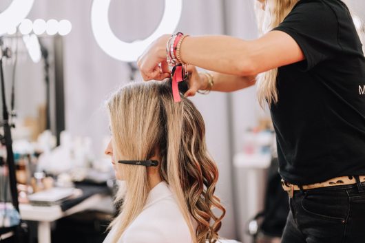 woman doing her hair on a backstage