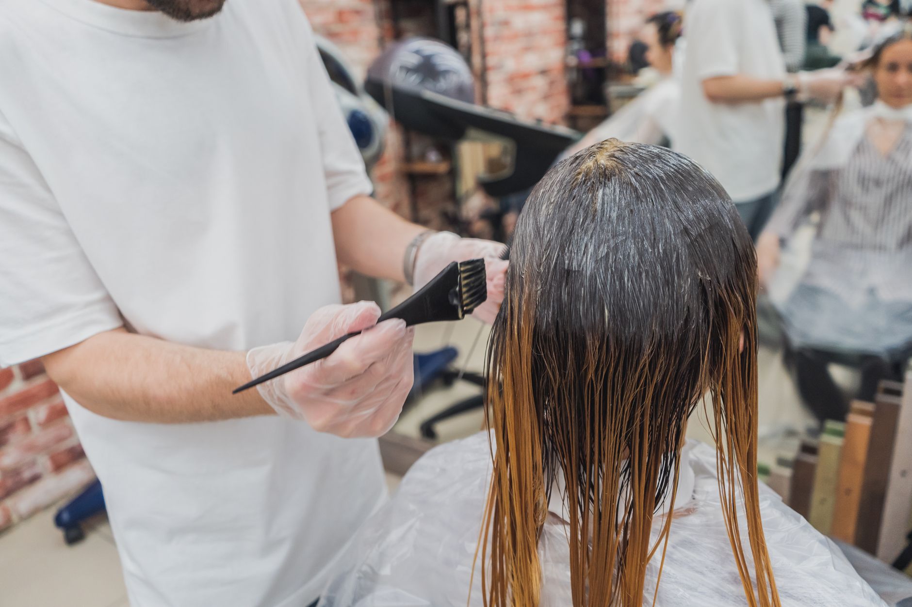 Custom Color Formulation: Bringing Your Hair Dreams to Life 1 person holding black brush