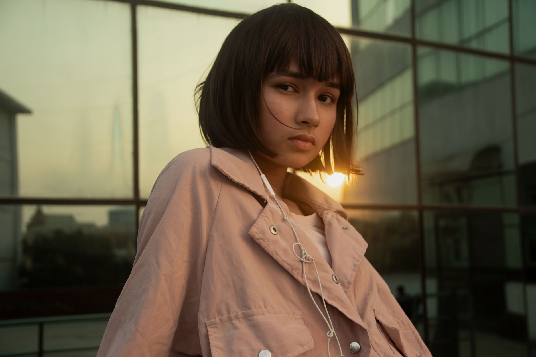 portrait photo of woman in peach jacket posing