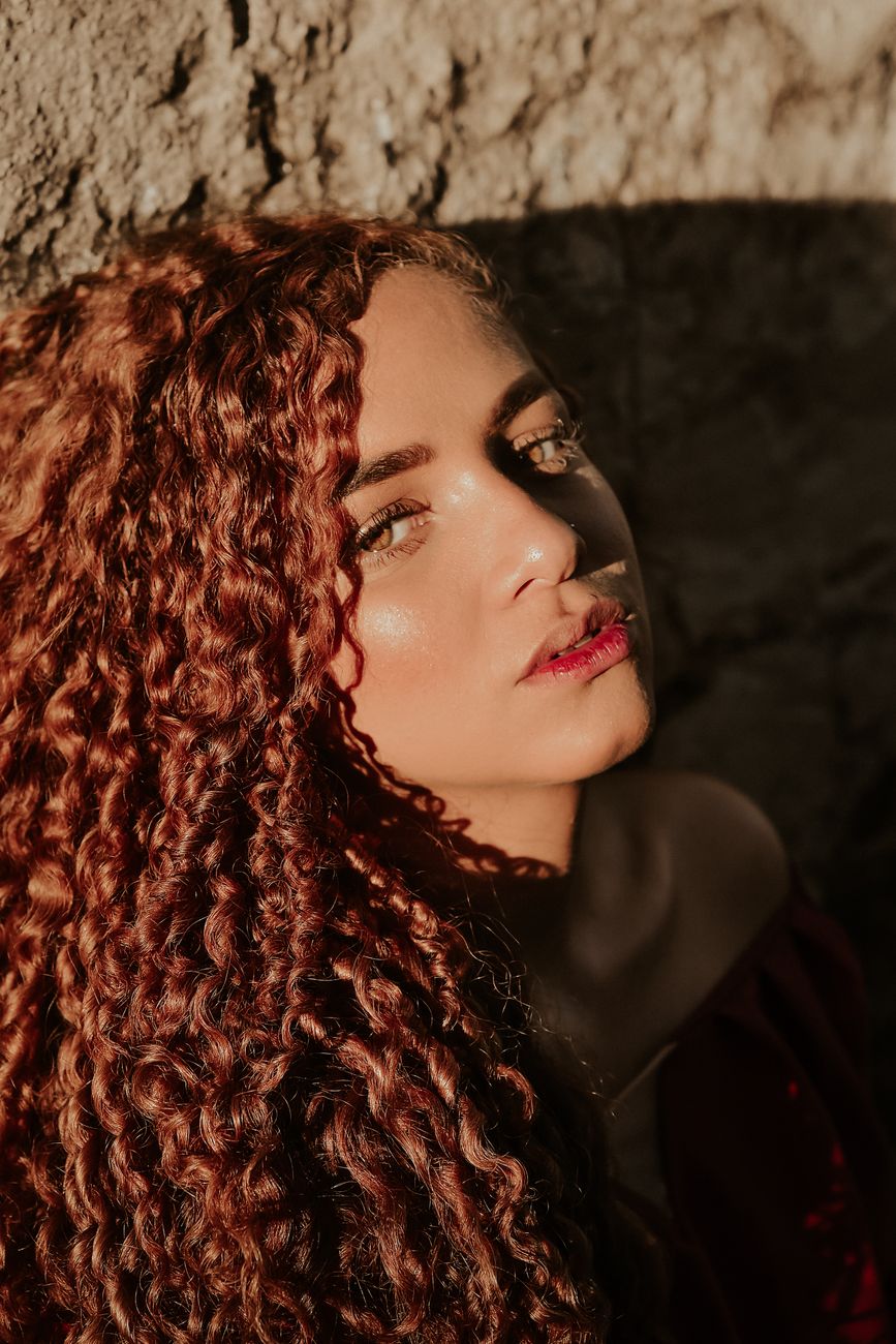 Bronze Balayage Refinements for Warm Hair 1 sunlit portrait of woman with curly hair