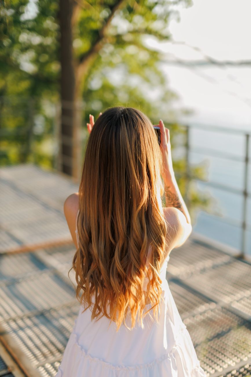 woman photographing scenic summer view