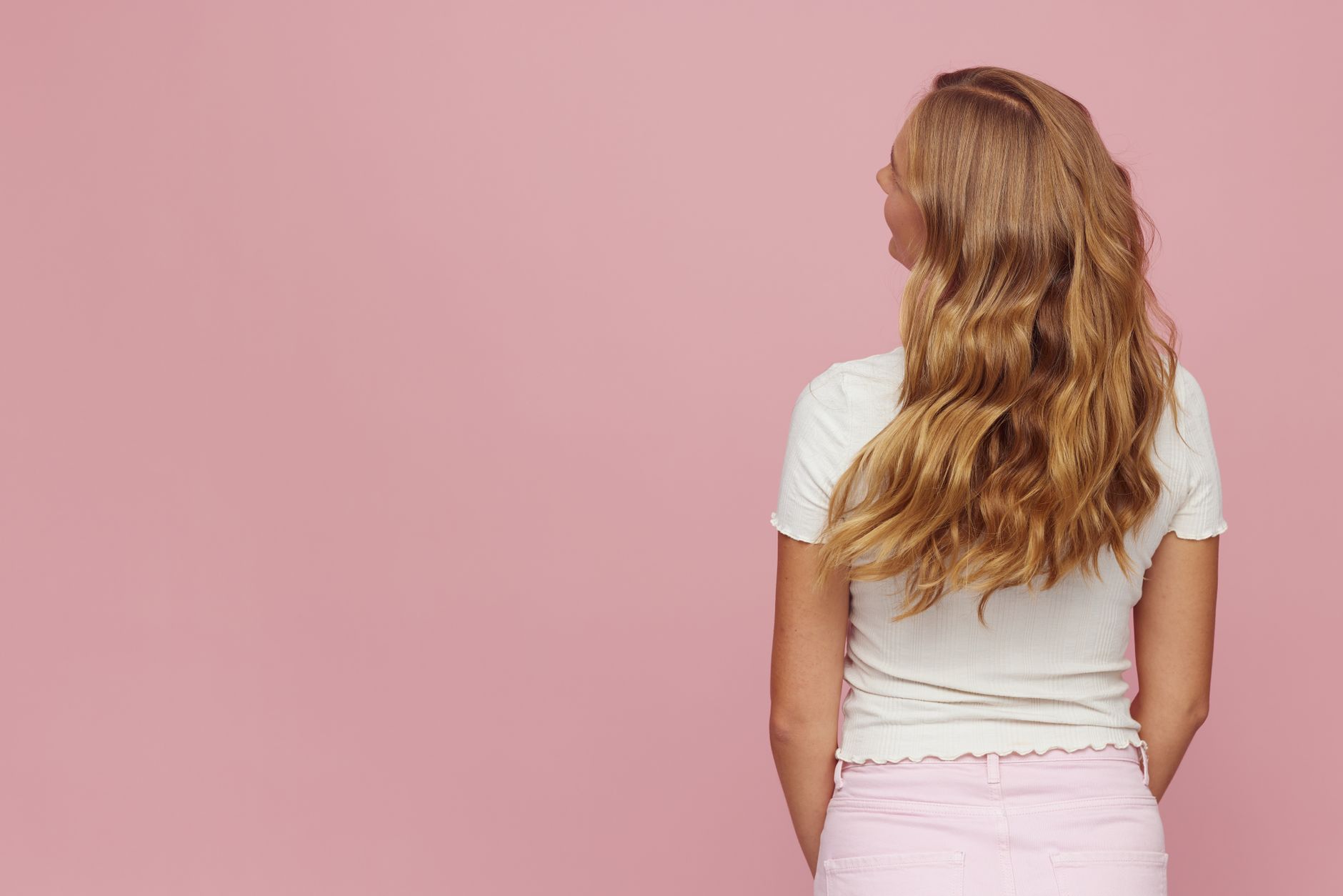 Pastel Pink Hair Care: Retaining Soft Pigments at Home 1 blonde woman s wavy hair on pink background