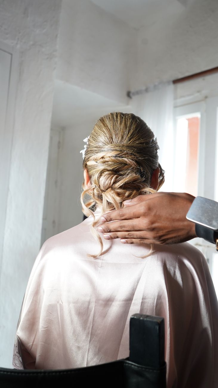 Bridal Party On-Site vs. Salon Prep Options 1 wedding hairstyle preparation in bright room