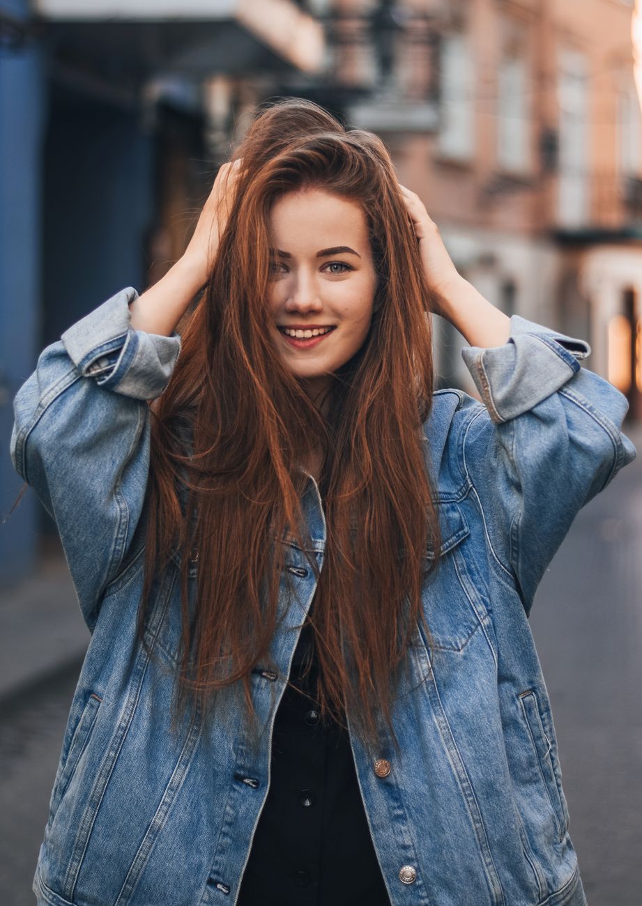 Cinnamon Spice Balayage Blends 1 joyful young female millennial standing on street and touching head