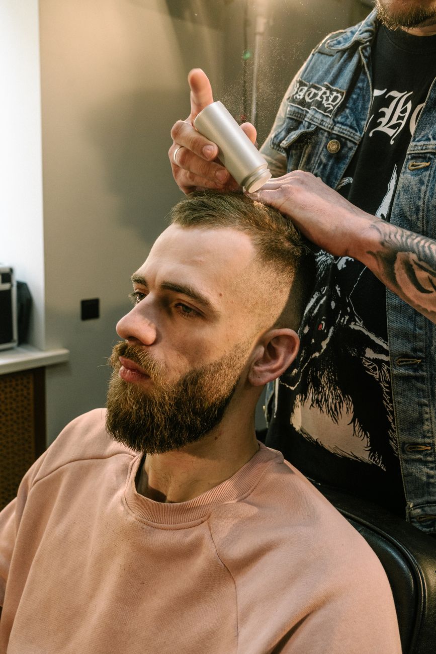 a bearded man sitting on a black chair