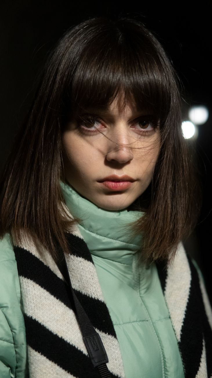 Precision Blunt Cuts for Fine Straight Hair 1 woman in outerwear with focused gaze on street