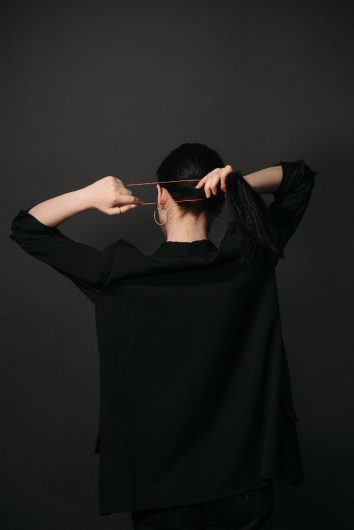a woman tying her hair