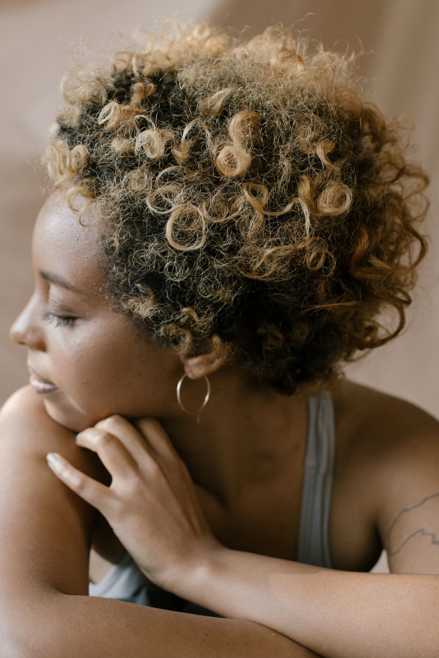 Low Porosity Hair Care: Penetrating Cuticles with Lightweight Hydration 1 woman with hoops earrings
