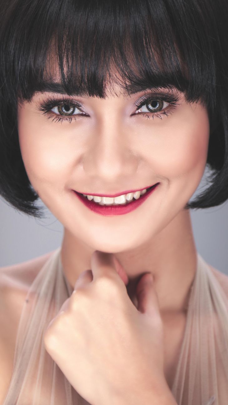 Bottleneck Bangs: The Flattering Trend Sweeping Salons 1 girl in brown halter neck dress