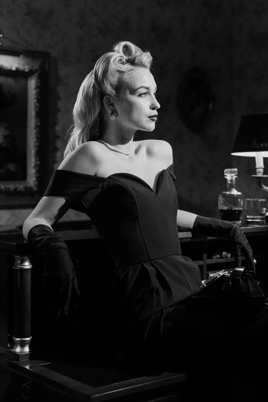 woman with blonde hair in black dress