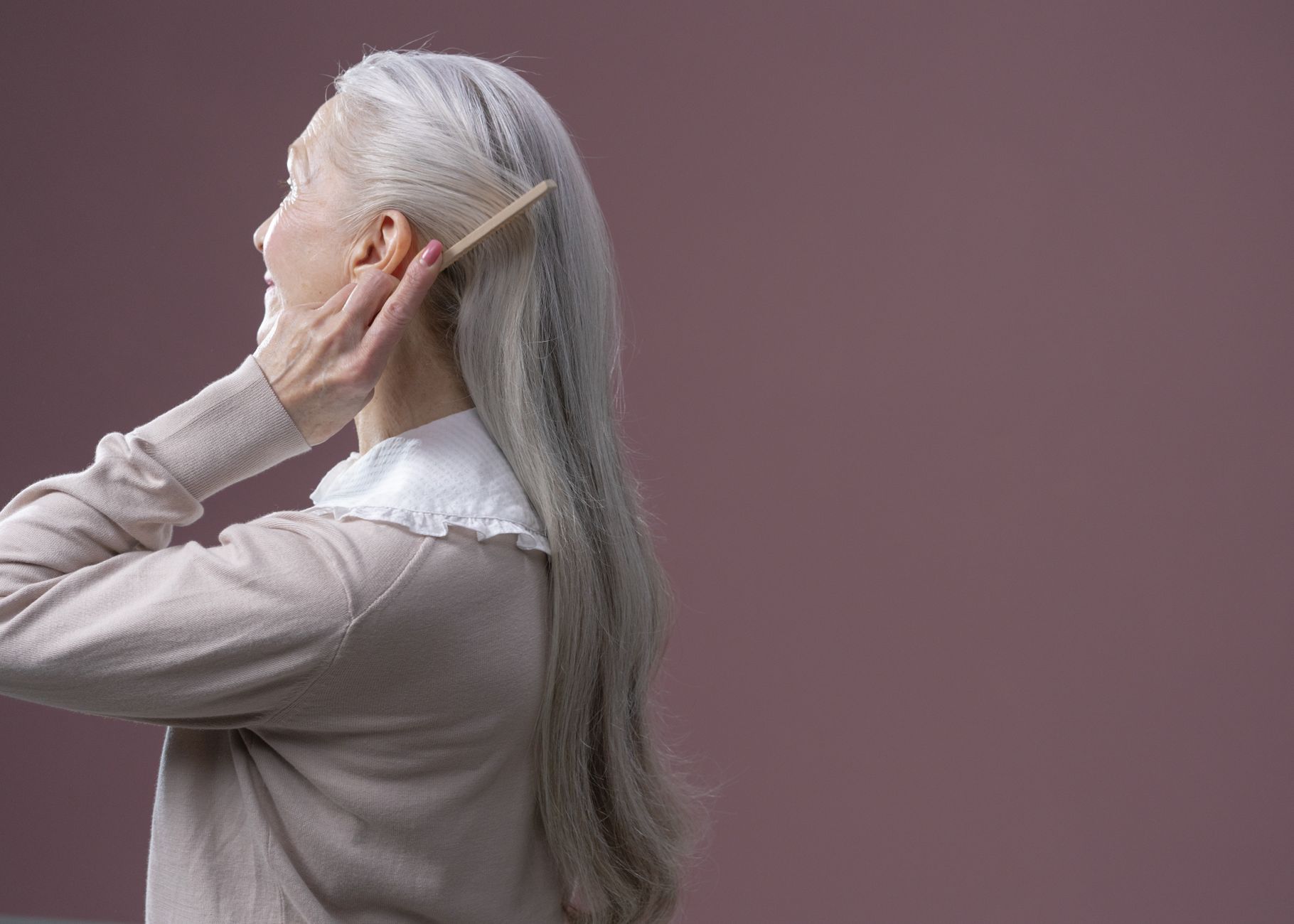 Lowlighting Silver and Gray Hair for Added Dimension 1 an elderly woman combing her hair
