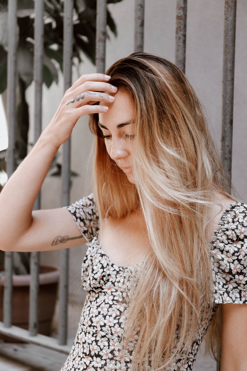 Hand-Painted Balayage Secrets for Natural Sun-Kissed Locks 1 young woman touching long fair hair