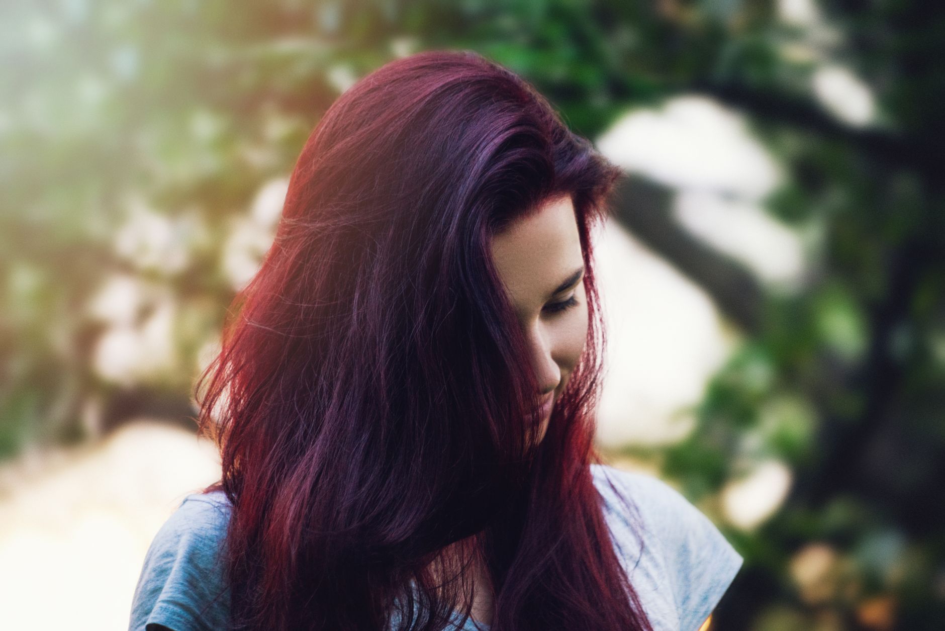 Berry Tones for Dark Hair: Rich Mulberry and Raspberry 1 woman wearing grey cap sleeve shirt beside green leaf tree during daytime